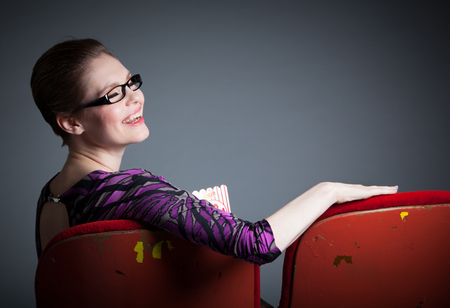 Attractive caucasian woman in the theatre in her 30 isolated on a grey backgroundの写真素材