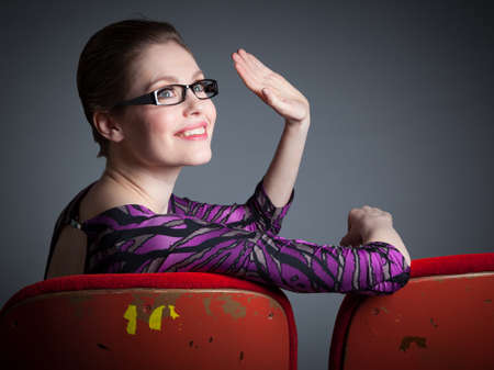 Attractive caucasian woman in the theatre in her 30 isolated on a grey backgroundの写真素材