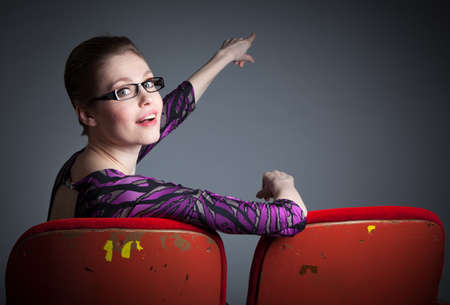 Attractive caucasian woman in the theatre in her 30 isolated on a grey backgroundの写真素材