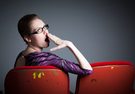 Attractive caucasian woman in the theatre in her 30 isolated on a grey backgroundの写真素材