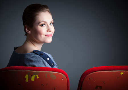 Attractive caucasian woman in the theatre in her 30 isolated on a grey backgroundの写真素材