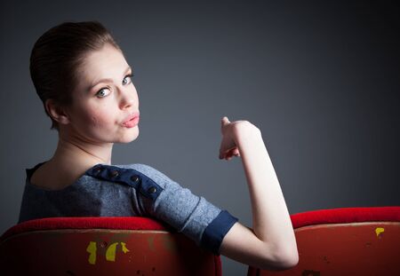 Attractive caucasian woman in the theatre in her 30 isolated on a grey backgroundの写真素材