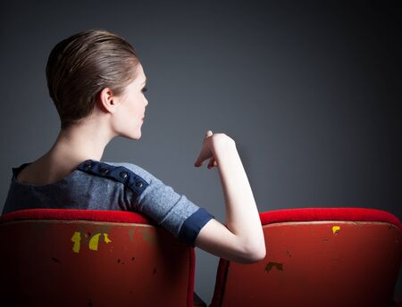 Attractive caucasian woman in the theatre in her 30 isolated on a grey backgroundの写真素材