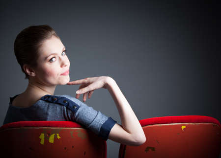 Attractive caucasian woman in the theatre in her 30 isolated on a grey backgroundの写真素材