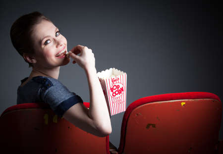 Attractive caucasian woman in the theatre in her 30 isolated on a grey backgroundの写真素材