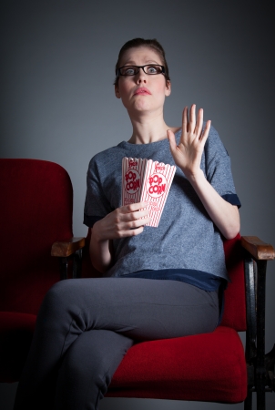 Attractive caucasian woman in the theatre in her 30 isolated on a grey backgroundの写真素材