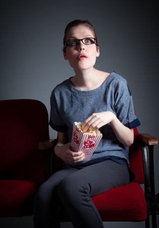 Attractive caucasian woman in the theatre in her 30 isolated on a grey backgroundの写真素材