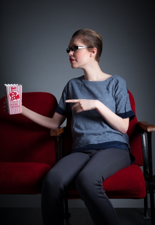 Attractive caucasian woman in the theatre in her 30 isolated on a grey backgroundの写真素材