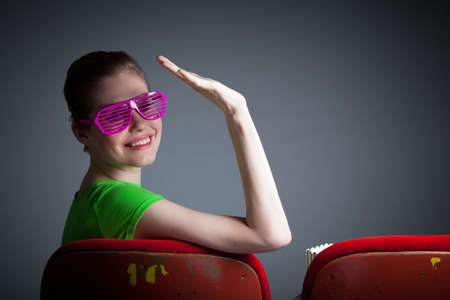 Attractive caucasian woman in the theatre in her 30 isolated on a grey backgroundの写真素材