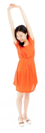 Attractive asian girl in her twenties isolated on a plein background shot in a studioの写真素材