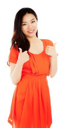 Attractive asian girl in her twenties isolated on a plein background shot in a studioの写真素材