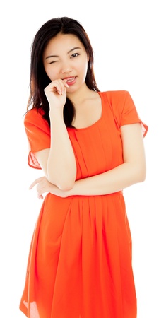 Attractive asian girl in her twenties isolated on a plein background shot in a studioの写真素材