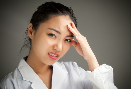 Attractive asian girl in her twenties isolated on a plein background shot in a studioの写真素材