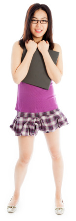 Attractive asian girl in her twenties isolated on a plein background shot in a studioの写真素材