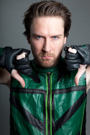 Attractive 30 years old caucasion man shot in studio isolated on a grey background