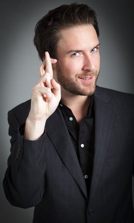 Attractive 30 years old caucasion man shot in studio isolated on a grey background