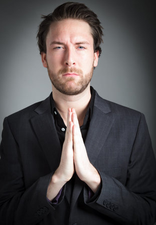 Attractive 30 years old caucasion man shot in studio isolated on a grey background