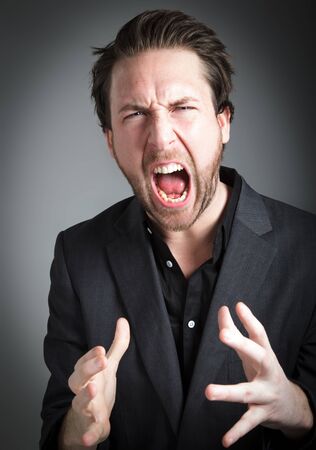 Attractive 30 years old caucasion man shot in studio isolated on a grey backgroundの写真素材