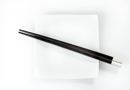 chopsticks on a plate isolated on a white background