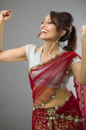 Young Indian woman celebrating successの写真素材