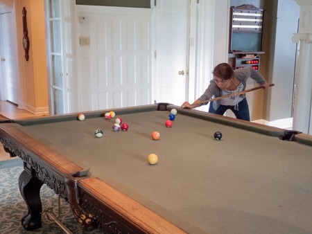 Young woman playing poolの写真素材