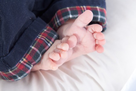 Close-up of bare feet of a baby boyの写真素材