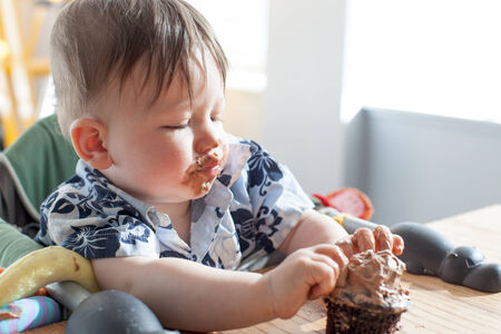Boy eating a birthday cakeの写真素材