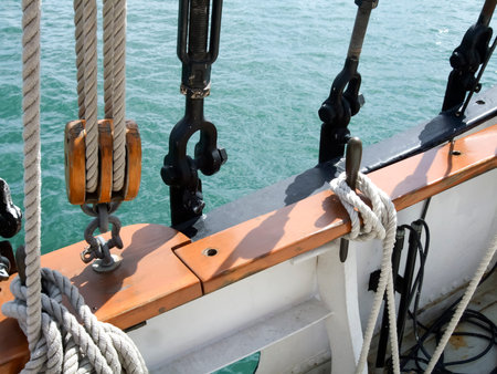 Close-up of rope tied up with pulley and hooks of boatの写真素材