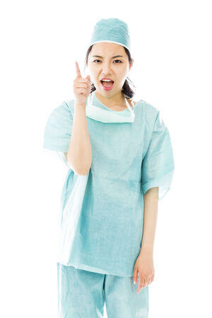 Angry Asian female surgeon scolding someone isolated on white backgroundの写真素材