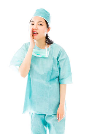 Asian female surgeon whispering message isolated on white backgroundの写真素材