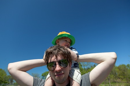 Man carrying his son on his shouldersの写真素材