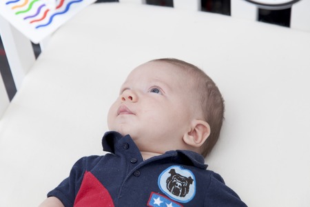 Close-up of a baby boy lying in a cribの写真素材