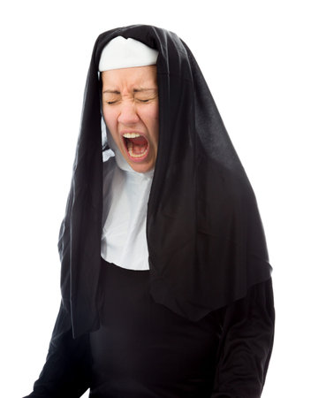 Young nun looking frustrated and shoutingの写真素材