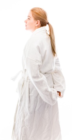 Side profile of a young woman standing in bathrobeの写真素材
