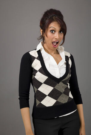 Indian businesswoman looking shocked isolated on colored backgroundの写真素材