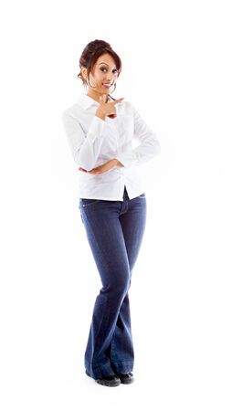 Indian young woman pointing backwardsの写真素材