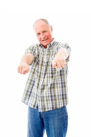 Confident senior man pointing towards camera with both handsの写真素材