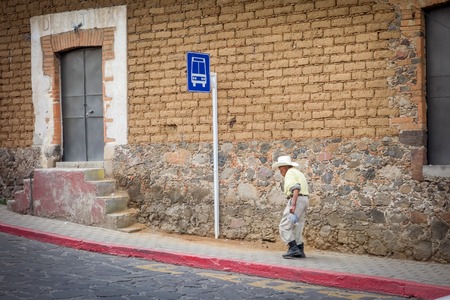 Man near a bus stop sign, Mexico City, Mexico 2013-06-08 4:23:43 PMのeditorial素材