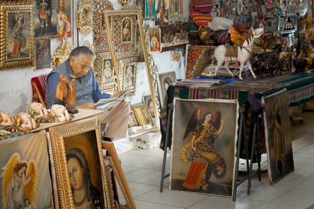 Shop owner reading newspaper in a souvenir store, Peru 2011-06-19 11:43:23 AMのeditorial素材