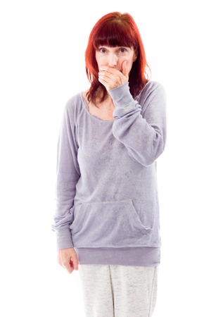 Mature woman covering mouth with her handの写真素材