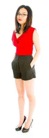 Young woman standing with her hands in pocketsの写真素材