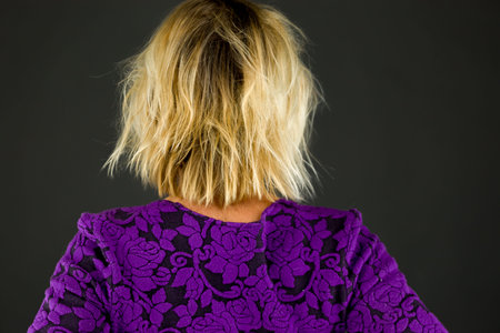 Model in studio isolated on plain grey backgroundの写真素材