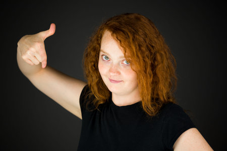 Model in studio isolated on plain grey backgroundの写真素材
