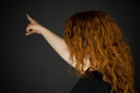 Model in studio isolated on plain grey backgroundの写真素材