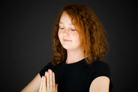 Model in studio isolated on plain grey backgroundの写真素材