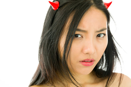 Attractive Asian young adult woman in angels and demon