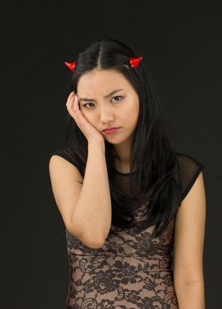 Attractive Asian young adult woman in angels and demonの写真素材