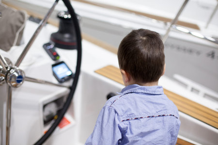 Rear view of a boy traveling in a yacht