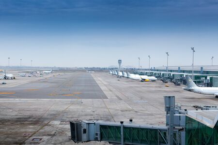 Airplanes parked at the terminal of an airportの写真素材