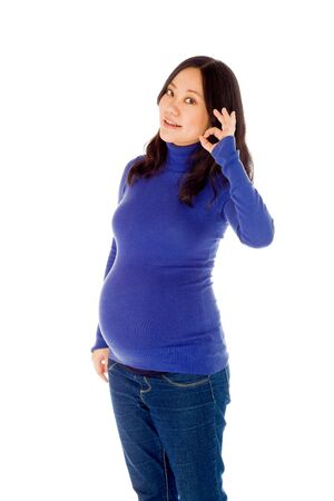 Pregnant adult asian woman isolated on white backgroundの写真素材